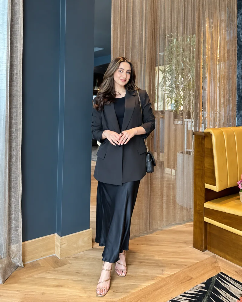 A black blazer with a long black skirt