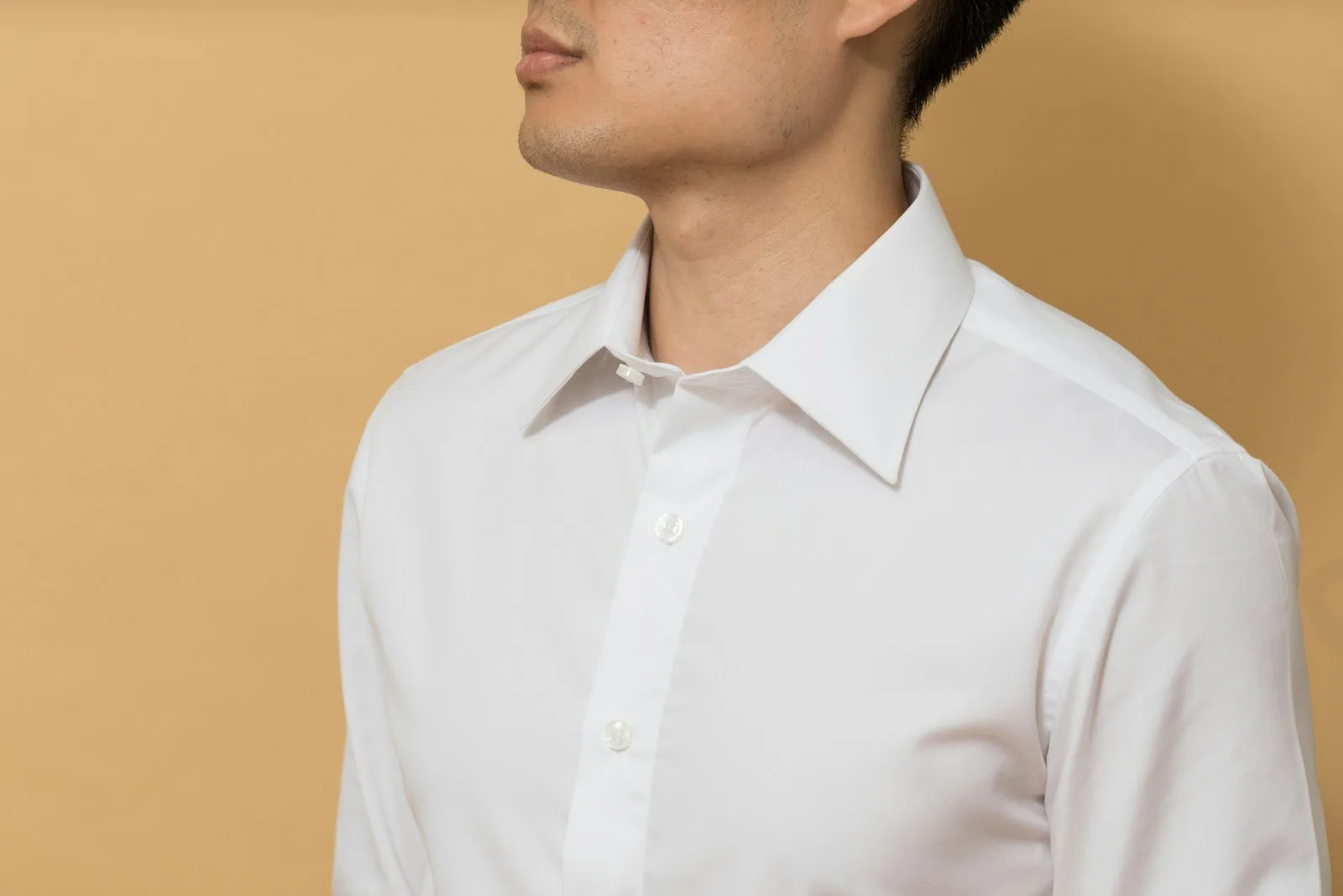 A man wearing a white button-up shirt in New York