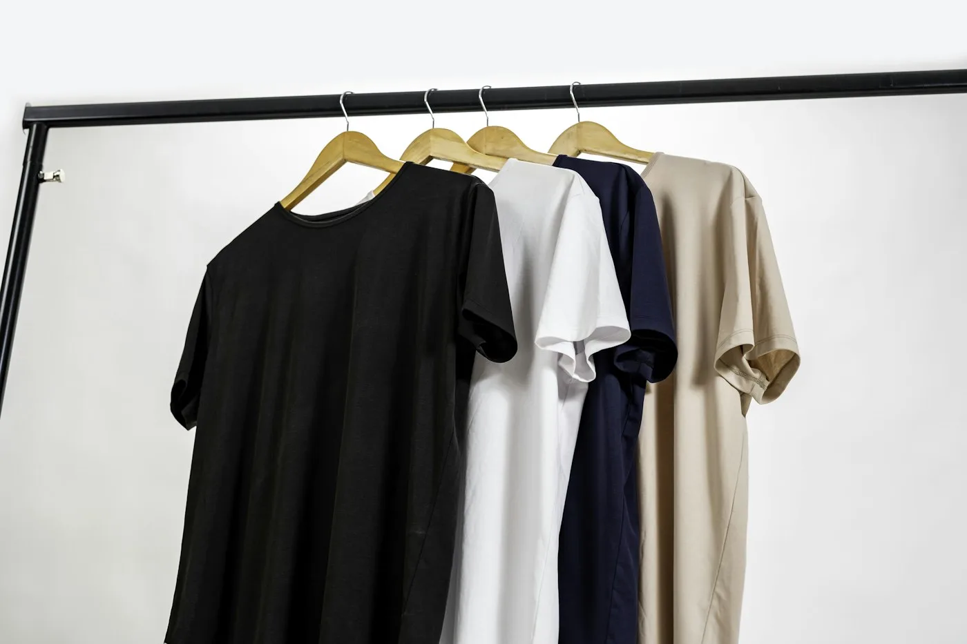 A selection of clothes hanging together on a wardrobe rail